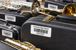 School band instrument cases labeled with durable barcode labels for tracking